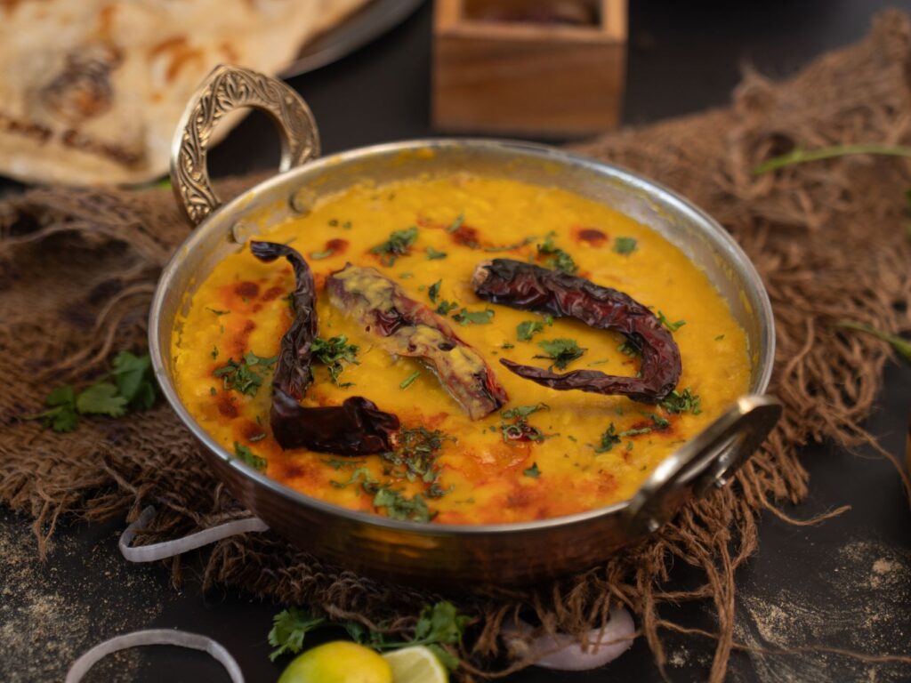 A traditional plate of dal bhat nepal with lentil soup, rice, vegetable curry and pickle
