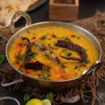 A traditional plate of dal bhat nepal with lentil soup, rice, vegetable curry and pickle