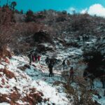 Trekkers walking toward snow-capped Himalayan peaks during the best time to visit Nepal