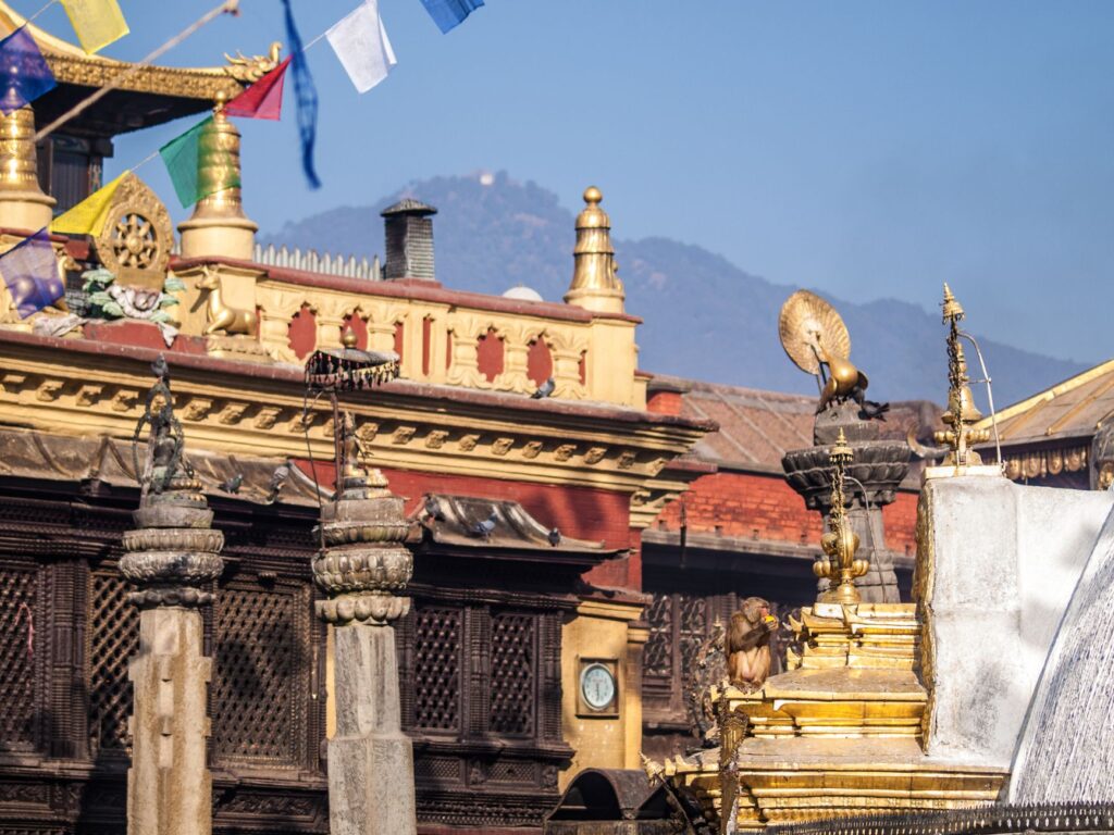 Nepal's unique non-rectangular flag flying against the Himalayan mountains, representing things only Nepal has