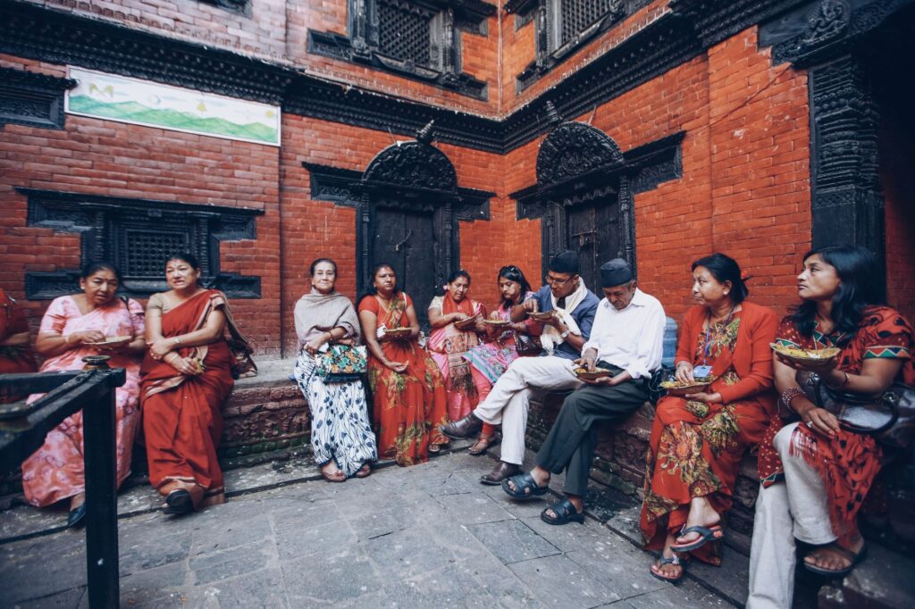 Tourists observing local customs near a Hindu temple in Kathmandu, Nepal